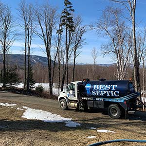 best septic truck in front of mountain view